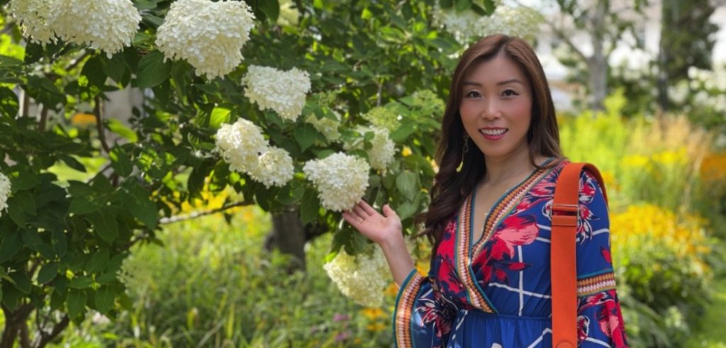 Eva Yanqiu Xu in beautiful garden, giving testimonial of Passion Test